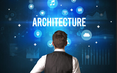 Rear view of a businessman with ARCHITECTURE inscription, modern technology concept