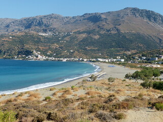 view of the coast of island Crete. Mediterranean nature. Long white sand beach. Village Plakias. Lybean blue calm sea. Summer vacation.