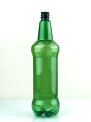 Green plastic bottle. Empty green bottle on a white background. Plastic beer bottle. PET bottle