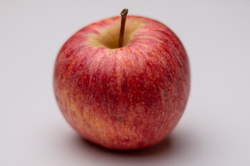 A red tasty red apple on a white background. Healthy fruit