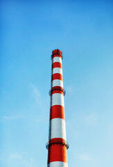 Factory chimney against blue sky
