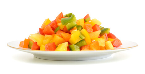 Yellow, red and green peppers Bulgarian. Slicing. Cubes in plate on white