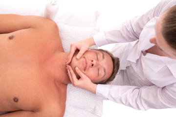 Fototapeta na wymiar Woman doing massage on face of male client
