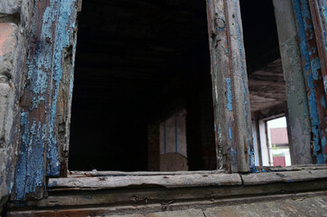Fototapeta na wymiar Abandoned brick building. A terrible house and crumbling walls.