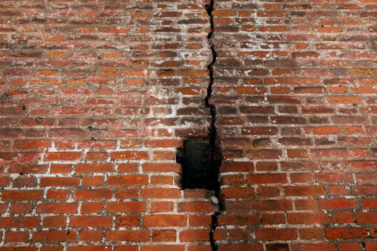 Crack in an old brick wall. Background, texture. © Miss Nim