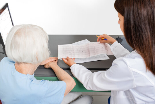 Cardiologist Consults An Elderly Woman On The Results Of An Electrocardiogram. Heart Attack, Test Results