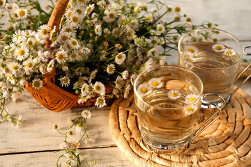 Fresh chamomile tea on a wooden table
