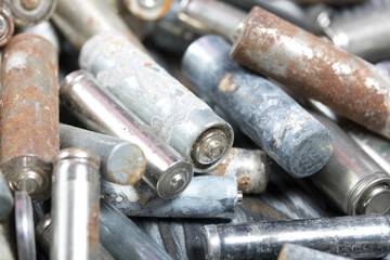 Corroded used batteries. On pine boards. Disposal of hazardous waste. Close-up shot.