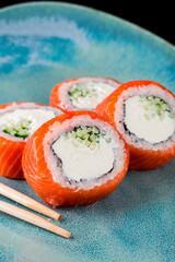 sushi roll Philadelphia salmon with cream cheese close-up, vertical food photo