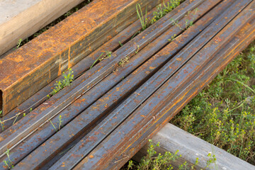 Rusty metal profile on the grass.