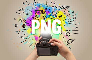 Close-up of a hand holding digital camera with abstract drawing and PNG inscription