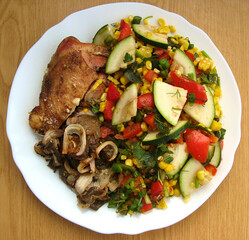 tomato salad, piece of meat, stewed vegetables close-up view