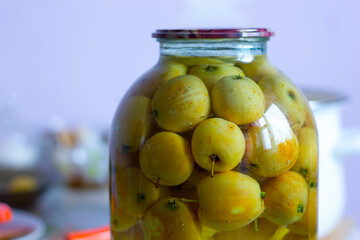 yellow small apples in a glass jar, apple compote for the winter