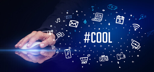 hand holding wireless peripheral with #COOL inscription, social media concept