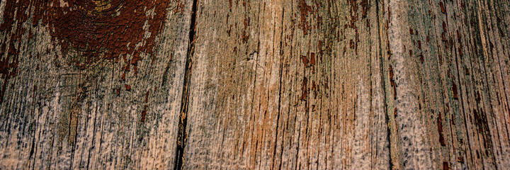 surface of the old wooden board is covered with cracks and scratches.