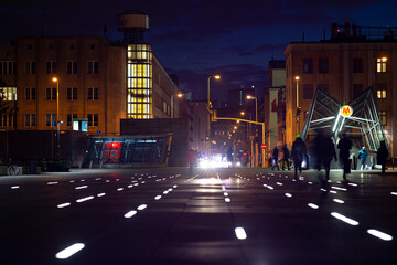 Fototapeta na wymiar People walking in the city street in the evening.