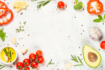 Herbs, spices and vegetables at white kitchen table.