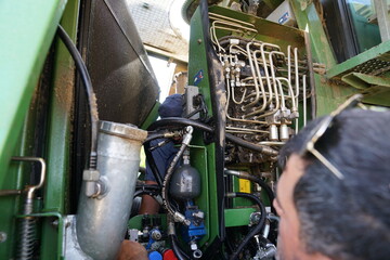 Combine harvester maintenance, repair of hydraulic systems by repairman, mechanisms power...