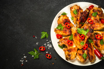 Grilled chicken wings at black.