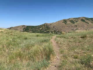 Path over mountainside through desert landscape, Utah