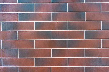 Red brick wall. Texture of dark brown and red brick with white filling
