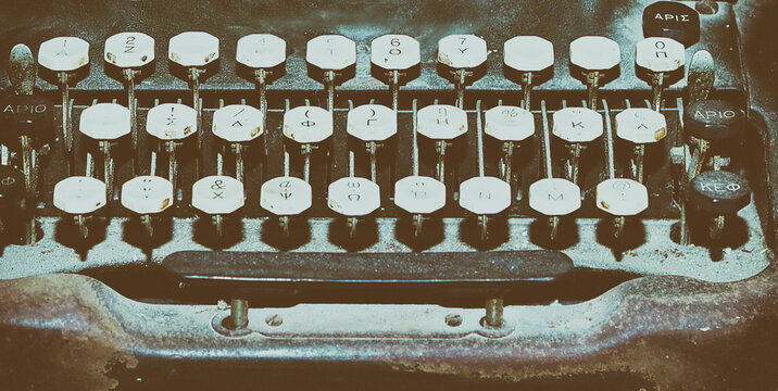 Vintage Typewriter. Close-Up. Grungy old dusty unfocussed front of typewriter with Greek fonts. Stock Image.
