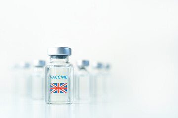 Transparent vials with UK flag. Vaccine for covid-19 coronavirus, flu, infectious diseases. Injection after clinical trials for vaccination of human, child, adult, senior. Medicine, drug concept