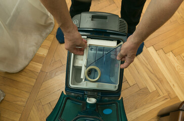 The process of cleaning a room with a vacuum cleaner with an aquafilter. Installation of a clean...