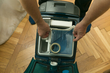 The process of cleaning a room with a vacuum cleaner with an aquafilter. Installation of a clean...