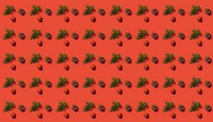 Creative pattern with a fir branch and a cone on a red background. The Concept Of Christmas