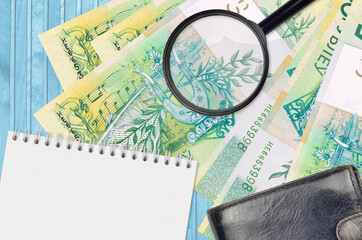 50 Belorussian rubles bills and magnifying glass with black purse and notepad. Concept of...