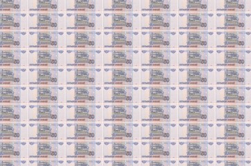 50 russian rubles bills printed in money production conveyor. Collage of many bills. Concept of...