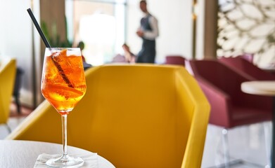 Glass of cold refreshing aperol spritz cocktail on table in summer.  