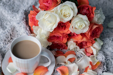 
Beautiful bouquet of roses with gifts and cafe.On a white background a beautiful bouquet of colorful roses.