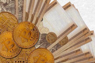2000 Hungarian forint bills and golden bitcoins. Cryptocurrency investment concept. Crypto mining...