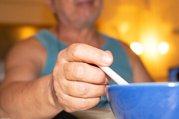 a man hands a spoon to the soup bowl