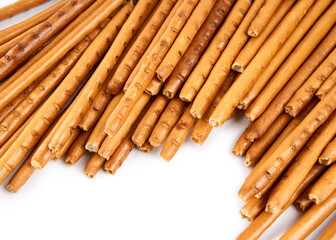 Creative layout made of crackers sticks on the white background. Food concept. Edible snack dry sticks with salt on white background. Straws, sticks crackers.