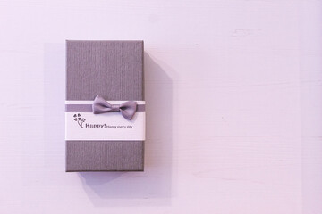 Gift box on a purple background. Box with an inscription. Present


