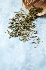 Dried Green Tea Leaves on Bright Background. Close up.	