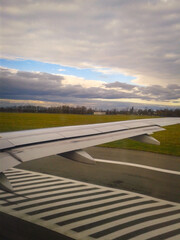 View Of The Runway And The Wing Of The Plane Through The Porthole