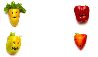 Multicolored stuffed peppers with various cutout faces in the skin on a white background. Concept...