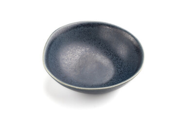 Empty blue ceramic bowl isolated on white background. Side view, close up.
