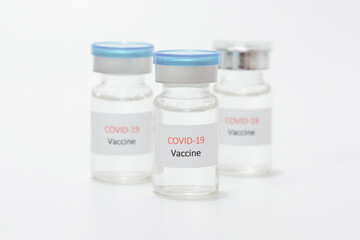 Vaccine COVID-19 (Coronavirus) in glass bottle on white