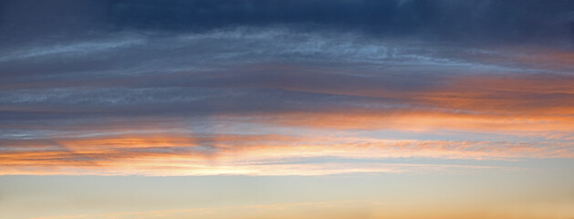 sky panorama with gray and orange clouds, above blue sky