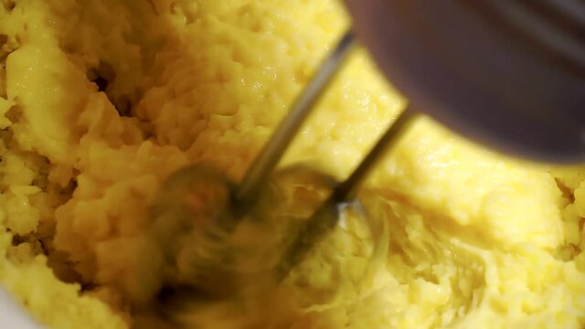 an electric mixer whips the mashed potatoes.close-up