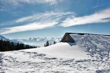 wooden house and roof under the snow