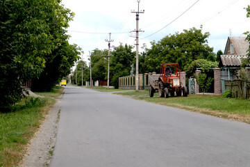 Fototapeta na wymiar Tractor on a country street