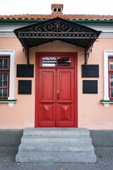 Fototapeta premium Vintage architecture classical facade building with red door