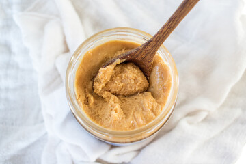 Delicious handmade peanut butter unlabeled on a white background. Superfood. Spreads