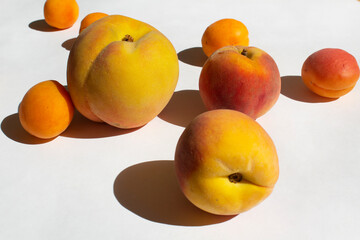 Orange ripe peach and yellow apricot fruit on white background energy vitamin diet concept 